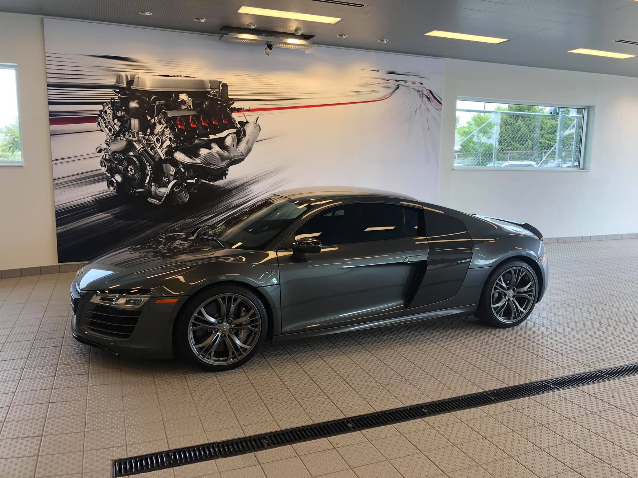 Left profile view of an Audi vehicle parked.